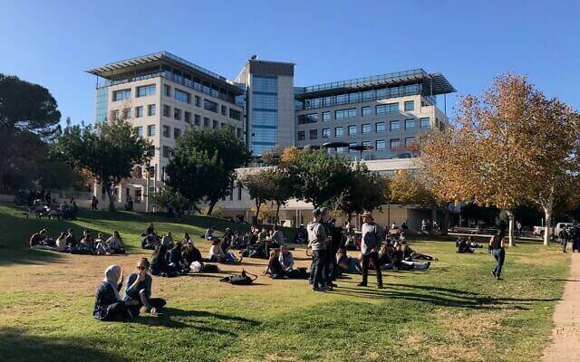 Technion students taking a break on the grass on a sunny winter day when entrepreneurs flocked to the Haifa campus to talk to students, December 19, 2019. (Shoshanna Solomon/Times of Israel)